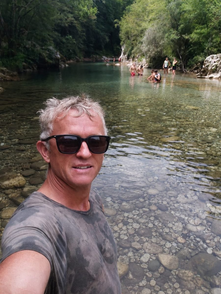 Ludolf beside a river on a hiking trip in Albania